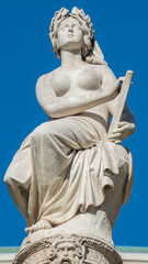 Fototapeta na wymiar Statue of beautiful woman as musician and singer of State Opera fountain in Vienna, Austria, details, closeup.