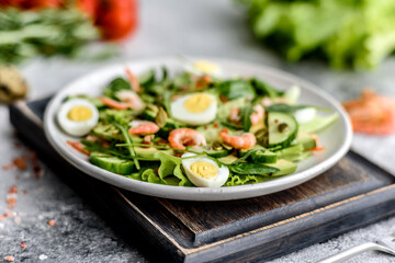 Salad with shrimp, avocado, cucumber, pumpkin seeds and flax seeds with olive oil