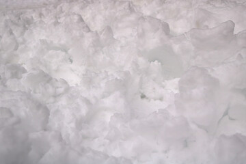 Fototapeta na wymiar white snow texture like clouds or waves in the floor - closeup clean but rough and irregular shapes