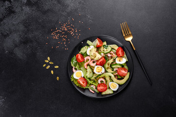 Salad with shrimp, avocado, cucumber, pumpkin seeds and flax seeds with olive oil