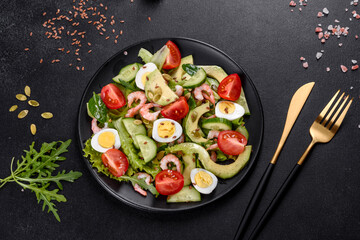 Salad with shrimp, avocado, cucumber, pumpkin seeds and flax seeds with olive oil