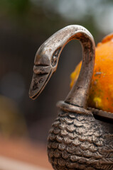 Detail close-up of a bronze fruit bawl with ornamental squash