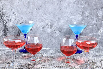Assortment of alcoholic cocktail with lemonade, wine, champagne, grog or martini in glasses on a...