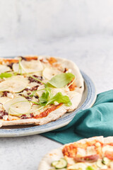 Homemade stone and mold pizzas with fresh vegetables and muzzarella