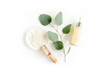 Eucalyptus essential oil, eucalyptus leaves on white background. Natural, Organic cosmetics products. Medicinal plant. Natural Serums. Flat lay, top view.