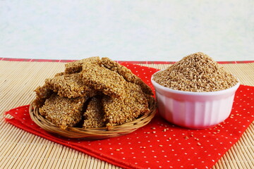 indian traditional homemade festival sweet til chikki made with sesame seed and gud or jaggery