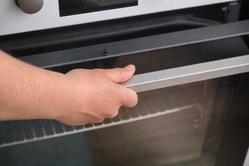 Woman opening an oven