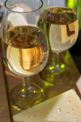 Glasses of dry fino sherry wine served with spanish tapas, manchego cheese, green olives, cheese crackers