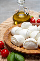 Tasty italian food, fresh white buffalo mozzarella soft cheese balls from Campania, tomatoes, fresh basil and olive oil