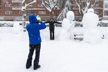 People enjoying the historical Snowtorm over Madrid city, Spain.