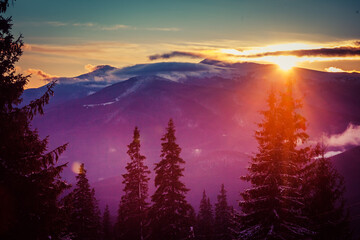 Beautiful dawn in the winter snow-covered mountains and amazingly beautiful clouds