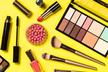Obraz na płótnie Canvas Makeup professional cosmetics on yellow background. Top view with copy space.