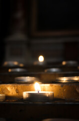 Close up view of burning candles in a church. Selective focus.