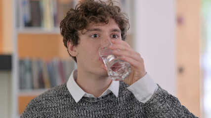 Fototapeta na wymiar Portrait of Young Man Drinking Water
