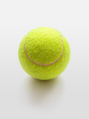 Yellow tennis ball on a light background