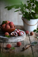 Fresh red lychee fruits.  Fresh organic lychee fruit on a rustic wooden background.