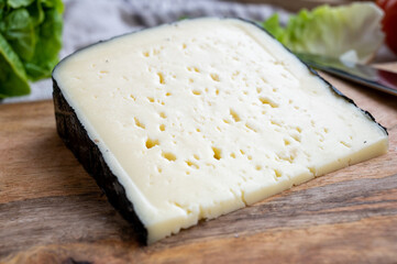 Cheese collection, French fol epi  cheese with many little holes, etorki, tomme noire des pyrenees and ossau iraty cheese