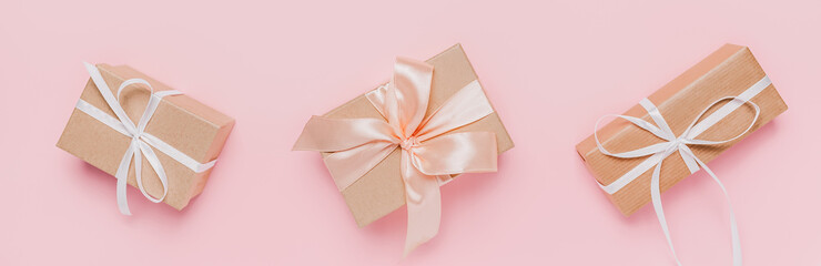 Gifts with wihte ribbon on isolated pink background, love and valentine concept