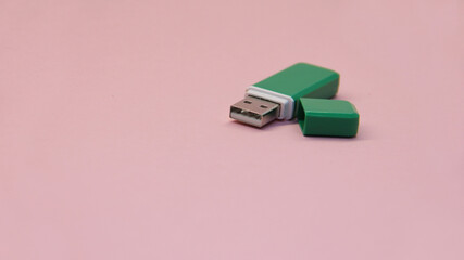 green USB flash drive with open lid on a light background