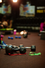 weights and fitness accessories in gym. hiit interval training. High intensity interval training group indoors. Group fitness training. Back view. 