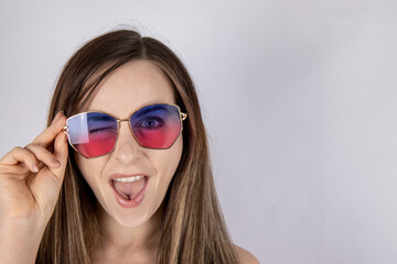 An attractive woman with long hair wearing summer sun glasses looking happy