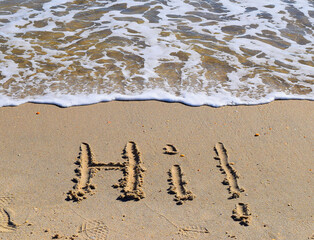 Hi - sand writing on the beach 