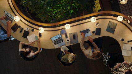 People discussing project in coworking. Creative team working overtime in office