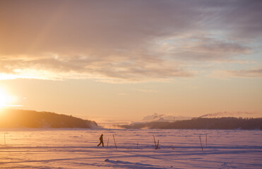 People walk on ice across the river. Winter and people in the morning.