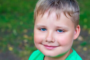 Close-up of a beautiful boy. Beautiful azure eye color.