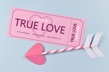 Pink 'True Love' ticket and cupid arrow on blue background. A concept for love and Valentine's day celebration