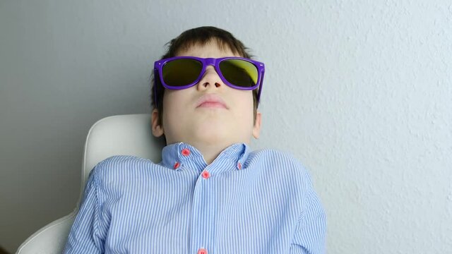 dentist, doctor examines oral cavity of small patient, molars grow, length of frenum of the tongue, boy, kid with open mouth, close up of child&rsquo;s teeth