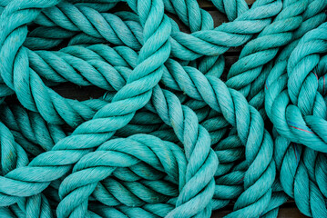 close up of rope on a blue background - obrazy, fototapety, plakaty