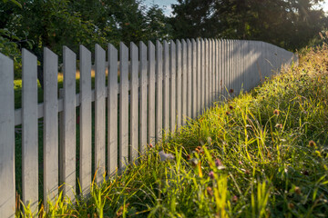 white picket fence and green grass