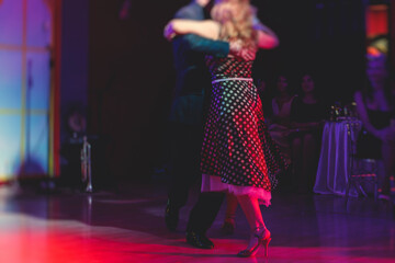 Couples dancing traditional latin argentinian dance milonga in the ballroom, tango salsa bachata...