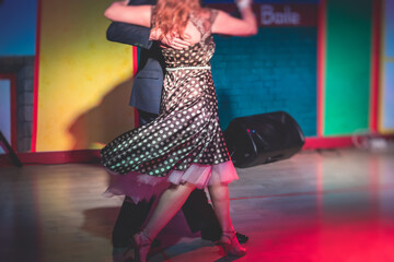 Couples dancing traditional latin argentinian dance milonga in the ballroom, tango salsa bachata...