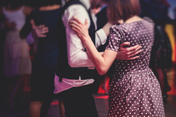 Couples dancing traditional latin argentinian dance milonga in the ballroom, tango salsa bachata...
