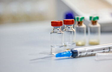 vaccine bottles and syringe for injection