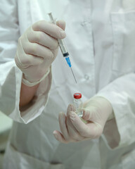 medical injection syringe in the nurse's hand