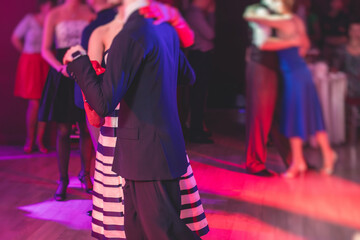 Couples dancing traditional latin argentinian dance milonga in the ballroom, tango salsa bachata...