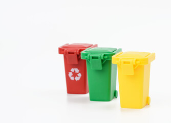 red, yellow and green plastic waste sorting container on white background