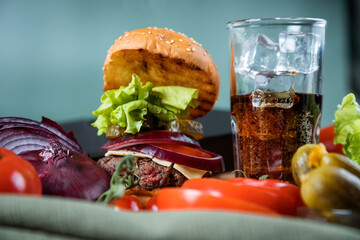 Classic burger and fizzy drink. Homemade hamburger. Meat and vegetables.