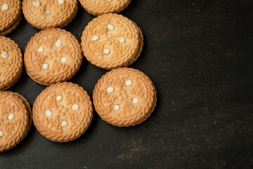 Vainilla baked cookies on a black kitchen desk 