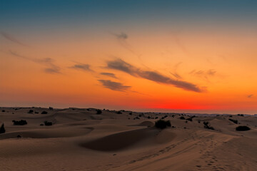 Sand dunes and a night sky after sunset in the desert outside Dubai, UAE in springtime