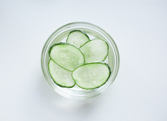 cucumber slices bowl white background top view