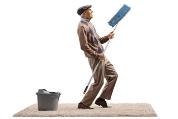 Elderly man singing and dancing with a cleaning mop and a bucket