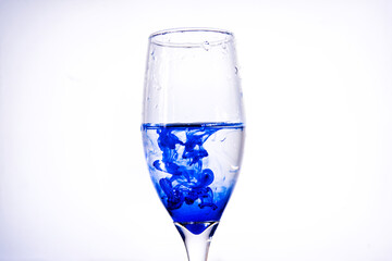 Ink in glass isolated in white background