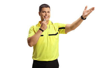 Smiling football referee blowing a whistle and pointing