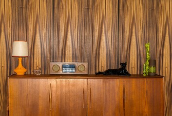 Retro 1970s teak cabinet with radio, lamp, ornament 