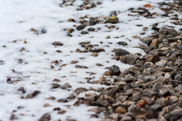 Small gravel road covered in snow texture. Winter pebble background. Dirty road. Fros morning. Snowy land
