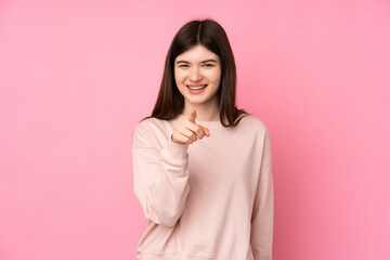 Fototapeta premium Young Ukrainian teenager girl over isolated pink background surprised and pointing front